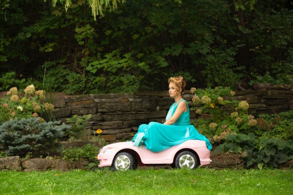 Joey ridding around in a toy car