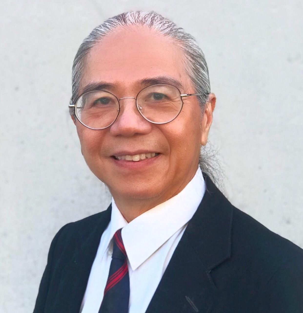 Headshot of Peter Bok, musician and music teacher, smiling.