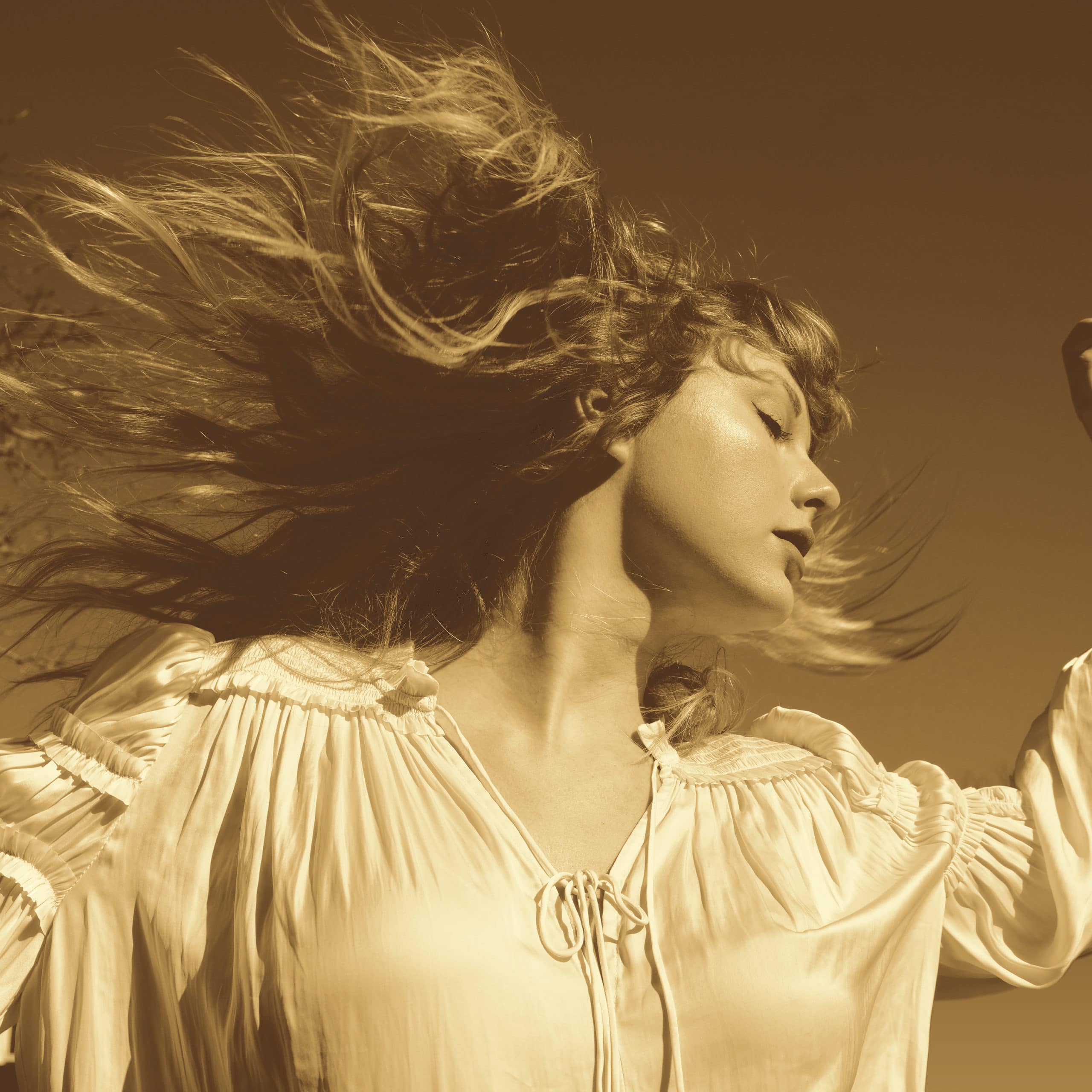 The cover to Taylor Swift's latest album "Fearless (Taylor's Version). Swift is facing right with her hair sprawled out in the other direction, she is wearing a white drawstring shirt