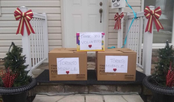 Brown boxes with white paper on them in front of a porch.