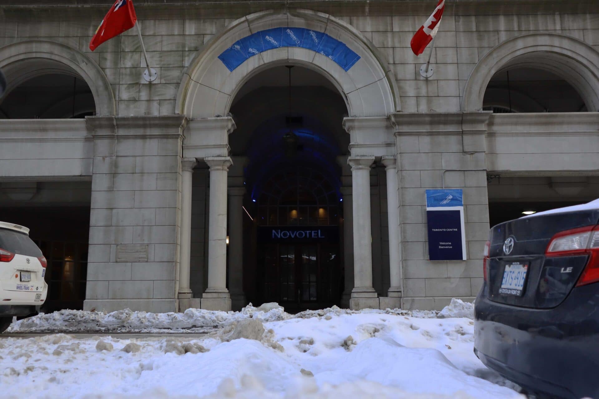 The sign, "Novotel", illuminates the front doors of the temporary hotel shelter located at 45 The Esplanade.