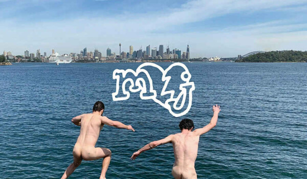 Two people jumping into a lake